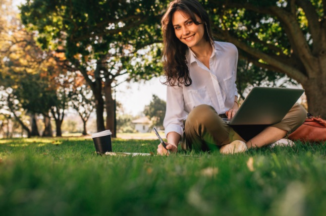 girl smiling while working on the green lawn